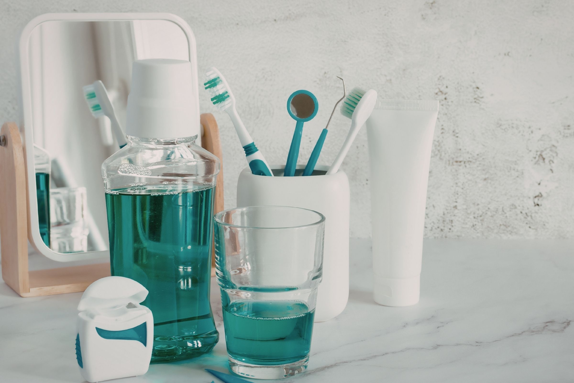 Generic oral health products on a bathroom shelf